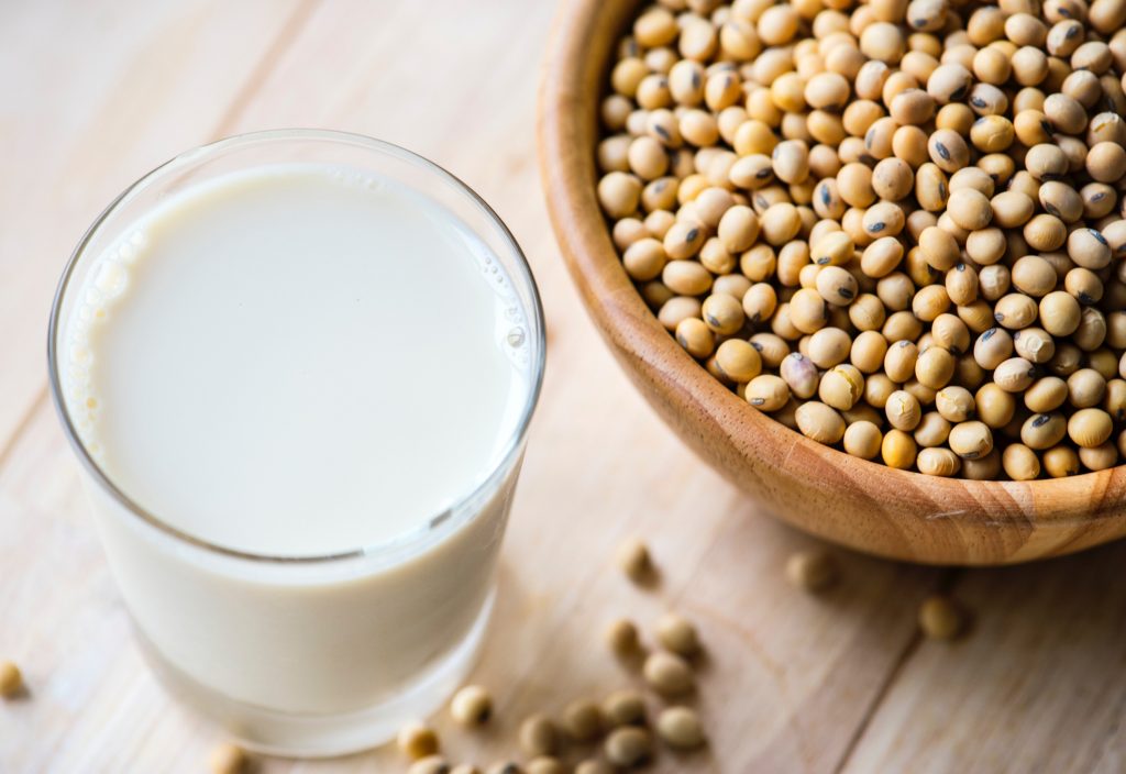 glass of milk and soy beans flat lay morning sickness remedies
